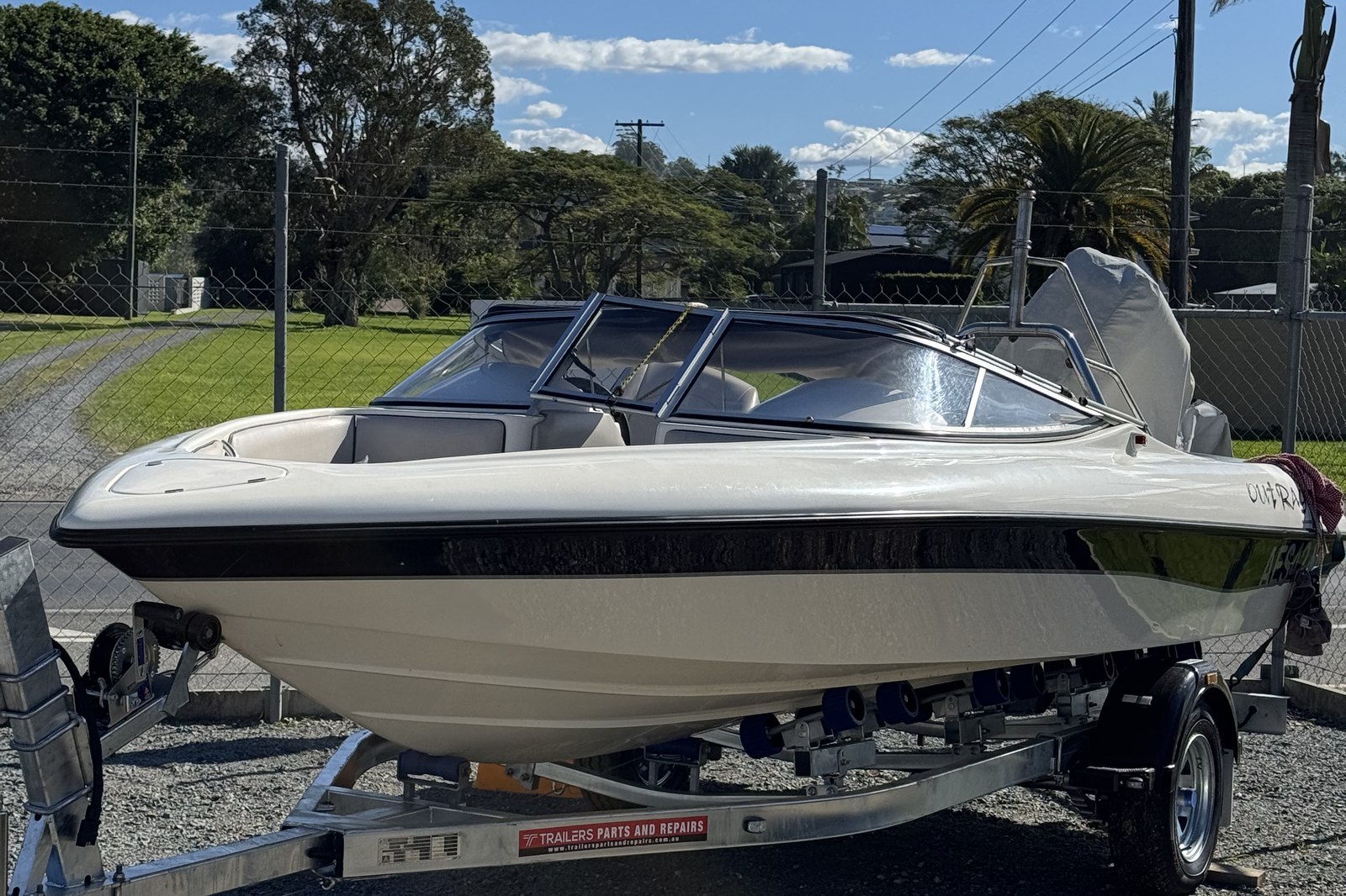 A detailed runabout on its trailer, hull polished to a high gloss