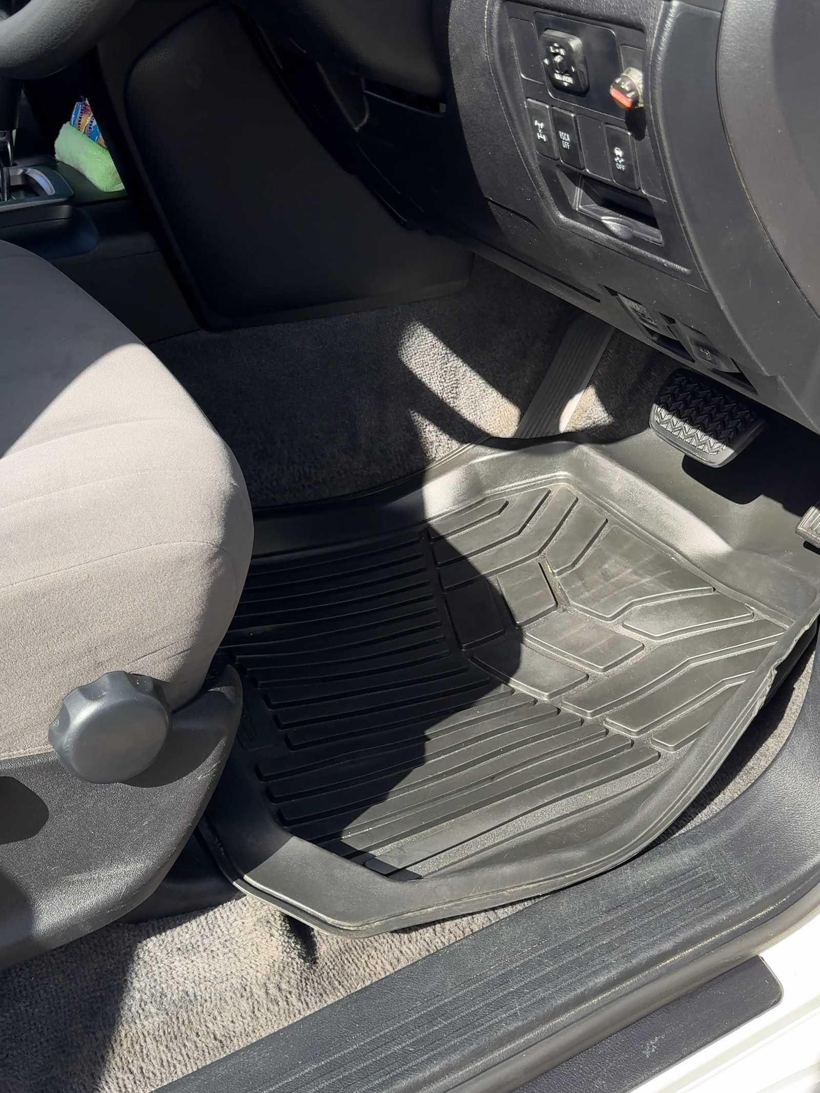 The same footwell after cleaning, the mat back to bare rubber and the sill clean